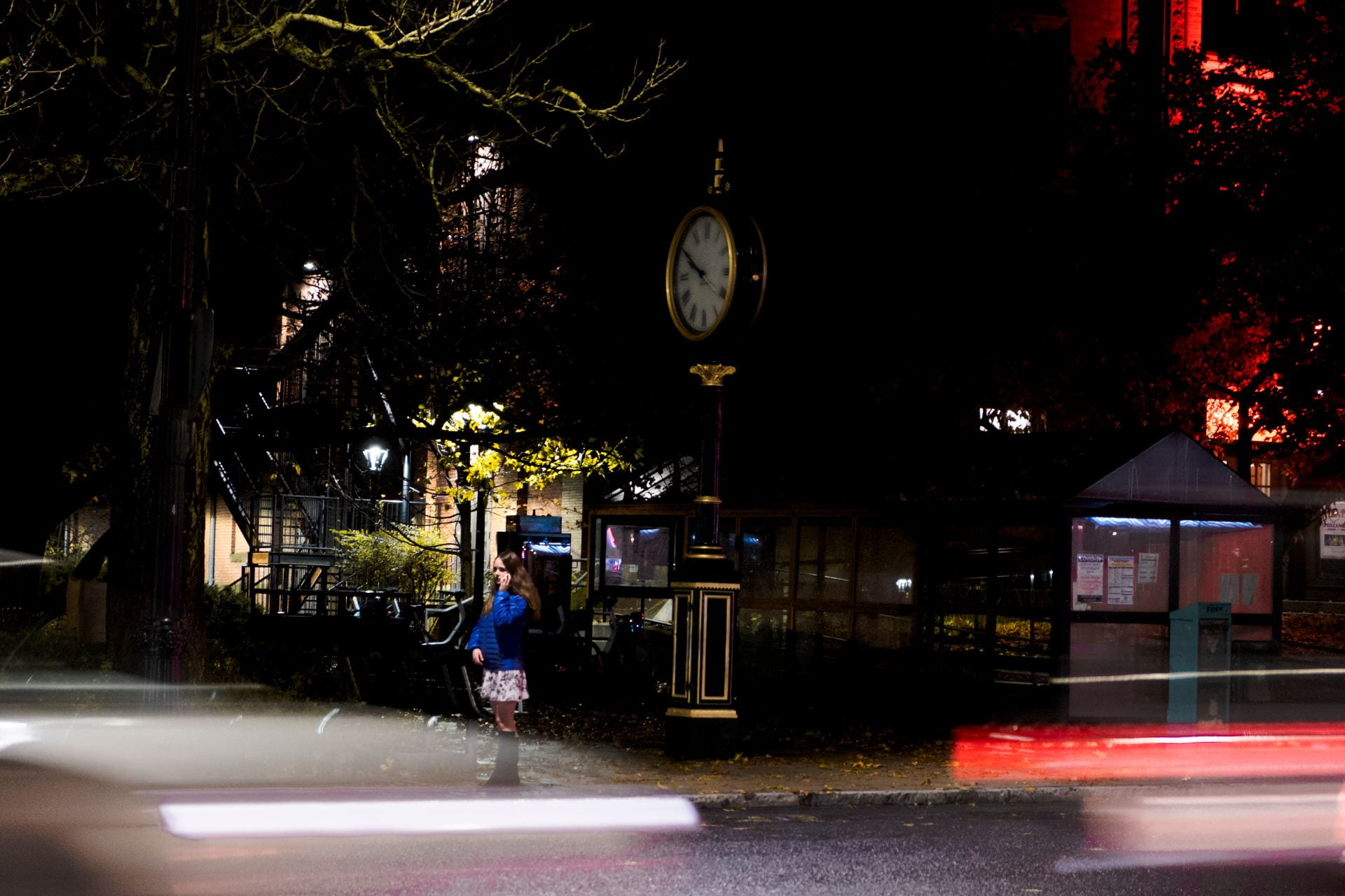 photo of a pedestrian crossing the street at night